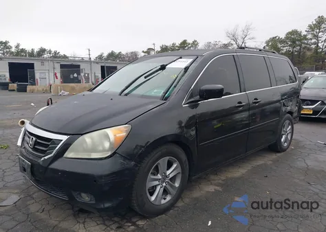 2010 Honda Odyssey Touring z USA, uszkodzony, nr VIN 5FNRL3H96AB049919